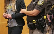 One of the two minor defendants accused of trying to kill a classmate to please the fictional horror character Slender Man is led into the courtroom in Waukesha, Wis., on Dec. 18, 2014. A Wisconsin state appeals court ruled today that the two girls, who were both 12 years old when they were accused, should be tried as adults. 