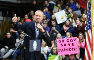 Gov. Bruce Rauner acknowledges the crowd’s applause before signing Senate Bill 2814, the Future Energy Jobs Bill, at Riverdale High School in Port Byron earlier this month. Today, Rauner donated $50 million to his 2018 gubernatorial campaign. 