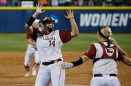 Oklahoma pitcher Paige Lowary (14) celebrates with catcher Lea Wodach after Oklahoma defeated Florida to win the NCAA Women's College World Series in Oklahoma City on June 6. For protection from batted balls, Lowary chooses to wear a facemask in the pitching circle, as do some softball infielders. 