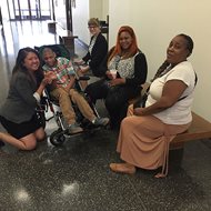 A Cook County jury on Wednesday awarded $53 million to Isaiah Ewing (middle left), who was born with a severe brain injury after suffering 12 hours of fetal distress during delivery. With him are (from left) Beam & Raymond paralegals Robin Kotow and Tiffany Skemp; Lisa Ewing, Isaiah’s mother; and Sherry Motley, Isaiah’s maternal grandmother. 