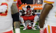 Kansas City Chiefs linebacker Tanoh Kpassagnon sits on the bench during the national anthem before an NFL football game against the Texans on Sunday in Houston. 