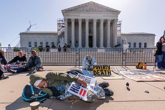 Activists demonstrate Monday at the Supreme Court on Capitol Hill as the justices consider a challenge to rulings that found punishing people for sleeping outside when shelter space is lacking amounts to unconstitutional cruel and unusual punishment.