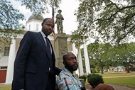 Ronnie Anderson (right), an African-American man charged with possession of a firearm by a convicted felon, poses on Aug. 1 with his lawyer Niles Haymer in front of a Confederate statue on the lawn of the East Feliciana Parish Courthouse where he is facing the charge. Anderson is asking for his case to be moved to another location because the courthouse where he’s being tried has a Confederate monument in front of it.