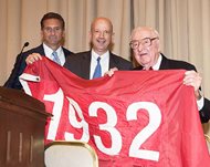 Retired U.S. Supreme Court justice John Paul Stevens (right) is joined by Chicago Bar Association President Daniel M. Kotin (left) and Michael Lufrano, the chief legal officer for the Chicago Cubs. In honor Stevens’ contributions to the law and his lifelong Cubs fandom, the Cubs presented the flag that hung over Wrigley Field commemorating the 1932 season. The Cubs went to the World Series that year, only to be swept by the New York Yankees; Stevens, then 12, attended Game 3 of the series. 