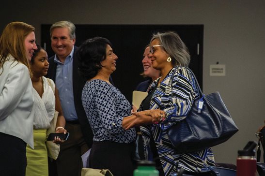 State Rep. Lisa Hernandez, center, who was elected chair of the Democratic Party of Illinois Saturday, embraces outgoing chair Robin Kelly, a congresswoman from Matteson. Hernandez was elected unanimously after a contentious effort by Hernandez’s backers, including Gov. J.B. Pritzker, to replace Kelly.