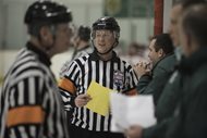 Lawyer Michael B. Barrett, supervisor of officials for the Amateur Hockey Association of Illinois and referee-in-chief for the Illinois Hockey Officials Association, talks to a coach before a game last month at the Southwest Ice Arena in Crestwood. 