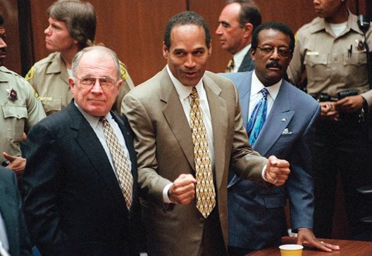In this Oct. 3, 1995, file photo, O.J. Simpson reacts as he is found not guilty in the death of his ex-wife Nicole Brown Simpson and her friend Ron Goldman. Defense attorneys F. Lee Bailey, left, and Johnnie L. Cochran Jr. stand with him.