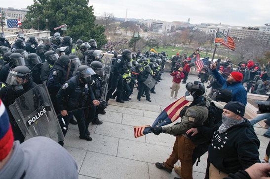 Rioters face off with police at the U.S. Capitol on Jan. 6, 2021, in Washington. A growing number of Capitol riot defendants are pushing to get their trials moved out of Washington. They claim they can't get a fair trial before unbiased jurors in the District of Columbia.
