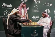 Two Saudi officials play chess during the opening of the first-ever chess tournament in Riyadh on Monday. Saudi Arabia is hosting a world chess tournament for the first time today, nearly two years after the country’s top cleric issued a religious edict against playing the board game. 