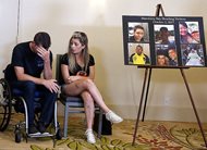 With his fiancee Fiorella Gaeta at his side, Jason McMillan, a 36-year-old Riverside County, Calif., sheriff's deputy shot and paralyzed in the Oct. 1 Las Vegas shooting, reacts after he talks about that evening at a news conference in Newport Beach, Calif., Monday. Victims of the fatal mass shooting at the country music festival are outraged they are being sued by MGM, which owns the hotel where the gunman opened fire.