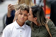 In this July 5, 2018 file photo, Sirley Silveira Paixao, an immigrant from Brazil seeking asylum, kisses her 10-years-old son Diego Magalhaes, after Diego was released from immigration detention in Chicago. A Justice Department filing hours before a hearing Friday, July 6 in San Diego says the administration needs more time to reunite all children with their parents by July 26 — and July 10 for children under 5. It says federal law requires it to complete reviews to ensure that the child is safe and that requires time.